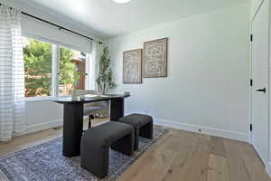 Office with baseboards and wood-type flooring