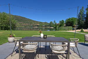 View of patio featuring outdoor dining space and a water and mountain view