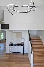 Stairway featuring wood finished floors and baseboards