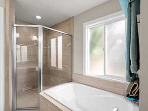 Full bathroom with healthy amount of natural light, a garden tub, a stall shower, and recessed lighting