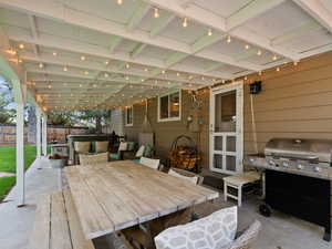 Fenced backyard with a patio area, grilling area, and outdoor dining area