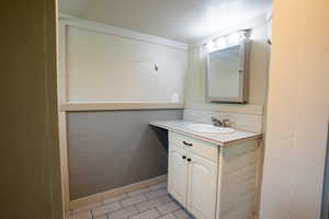 Bathroom with vanity and tile flooring.