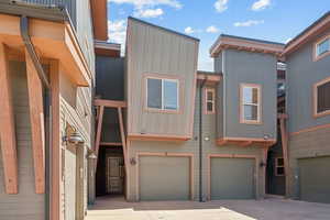 View of front facade featuring driveway and an attached garage
