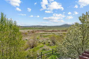 View of mountain backdrop with rural landscape