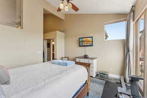 Bedroom featuring wood finished floors, a ceiling fan, and baseboards