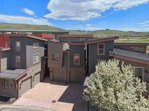 View of front of home featuring an attached garage, concrete driveway, and a mountain view
