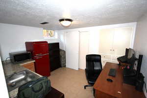 Home office featuring a textured ceiling and light tile patterned floors