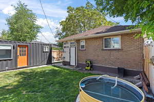 back yard view with tiny home that includes 1 bathroom 120 sqft living space