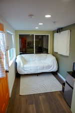 Bedroom featuring baseboards, wood finished floors, and recessed lighting
