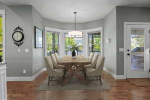Sunny Dining Room with hardwood floors virtually staged