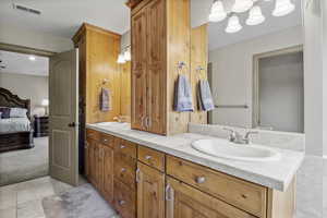 Primary spa style bathroom with oversized jetted tub, double vanity and built in storage cabinet, travertine steam shower with bench.