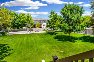 Beautiful large fully fenced backyard with mature trees, inground trampoline, sports court with basketball, shuffleboard and flood lighting.