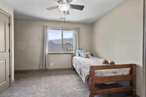 One of 4 upstairs bedrooms with a ceiling fan and large window for tons of natural light