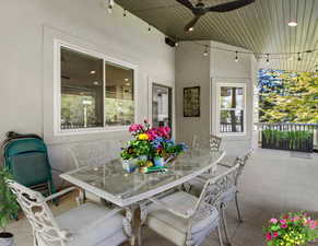 View of patio featuring outdoor dining space and ceiling fan