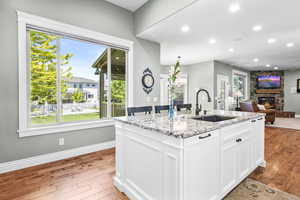 Open kitchen with large island with seating, stainless steel appliances and granite countertops