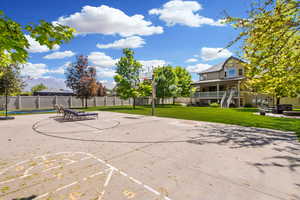 Sports court with basketball, shuffleboard and flood lighting