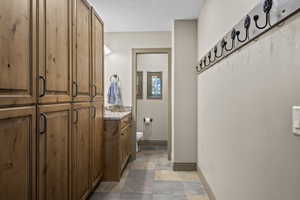Mudroom drop zone with cabinet lockers and a convenient 1/2 bath