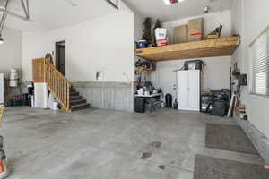 Oversized 3 car garage with storage loft and man door to the RV pad.