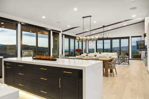 Kitchen featuring light countertops, recessed lighting, light wood-style floors, open floor plan, and lofted ceiling