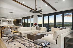 Living area featuring a chandelier, light wood-style floors, and recessed lighting