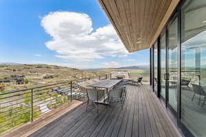 Deck featuring a mountain view and outdoor dining space