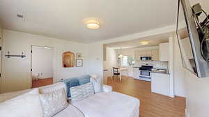 Living area featuring light wood-type flooring and baseboards
