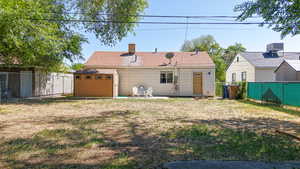Back of property featuring a chimney and central AC unit