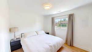 Bedroom featuring light wood finished floors and baseboards