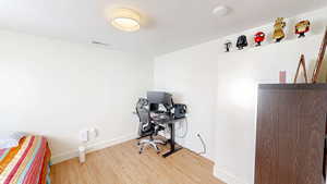 Office with wood finished floors and baseboards