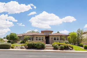 Mediterranean / spanish-style house featuring stucco siding and a tiled roof