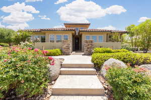Mediterranean / spanish home featuring a tiled roof and stucco siding