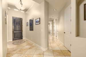 Foyer featuring recessed lighting, light tile patterned floors, and baseboards