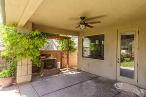 View of patio featuring ceiling fan