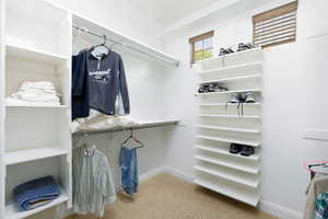 Spacious closet with carpet flooring