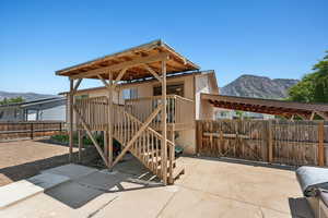 View of patio / terrace featuring a mountain view and a gate