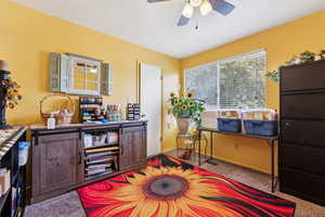 Carpeted office space with ceiling fan