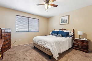 Bedroom with carpet, baseboards, and a ceiling fan