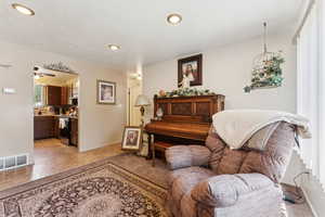 Living room with recessed lighting, a ceiling fan, and baseboards