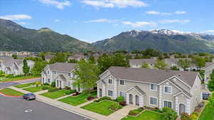 View of mountain backdrop featuring nearby suburban area