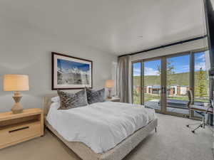 Bedroom featuring carpet floors and access to outdoor patio and hot tub