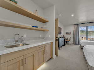 Indoor bar with light carpet, recessed lighting, and baseboards