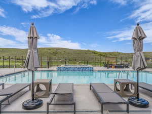 View of swimming pool with a pool with connected hot tub