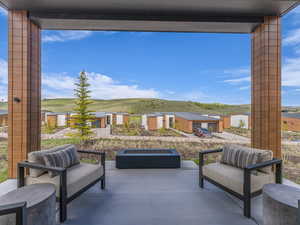 View of patio with a fire pit and mountain view