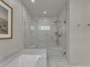 Full bathroom with recessed lighting, a marble finish shower, and marble look tile flooring