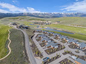 Aerial perspective of suburban area featuring a water and mountain view and a golf club