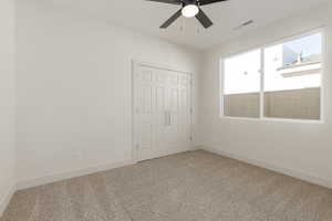 Unfurnished bedroom with carpet floors, baseboards, and a closet