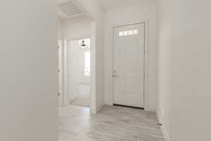 Entryway featuring baseboards and light wood-style floors
