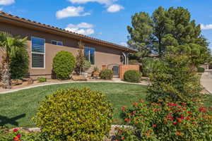 View of front of property with stucco siding, a front lawn, and a gate