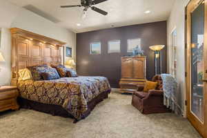 Bedroom featuring light carpet, recessed lighting, and a ceiling fan