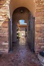 Entrance to property with stone siding and stucco siding